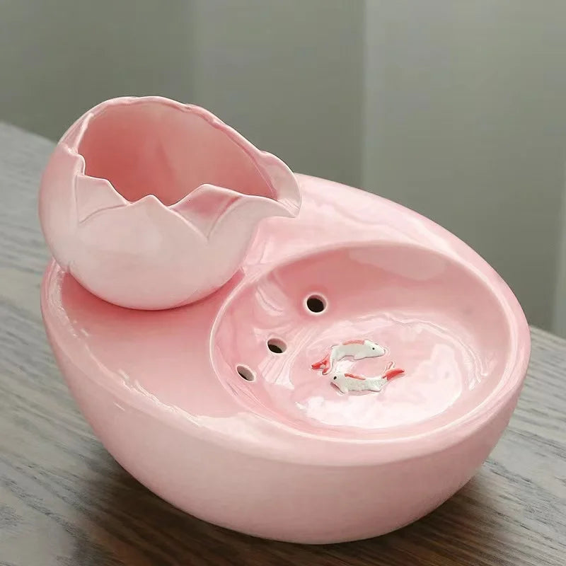 Ceramic pet water fountain with USB pump for cats and other pets to drink water.