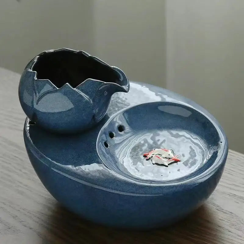 Ceramic pet water fountain with USB pump for cats and other pets to drink water.