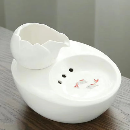 Ceramic pet water fountain with USB pump for cats and other pets to drink water.