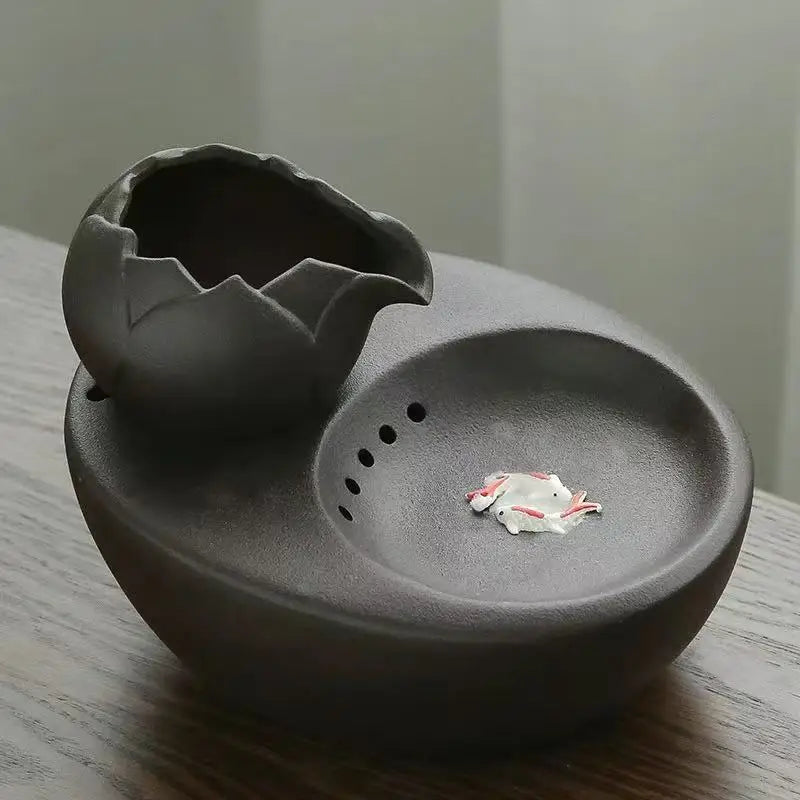 Ceramic pet water fountain with USB pump for cats and other pets to drink water.